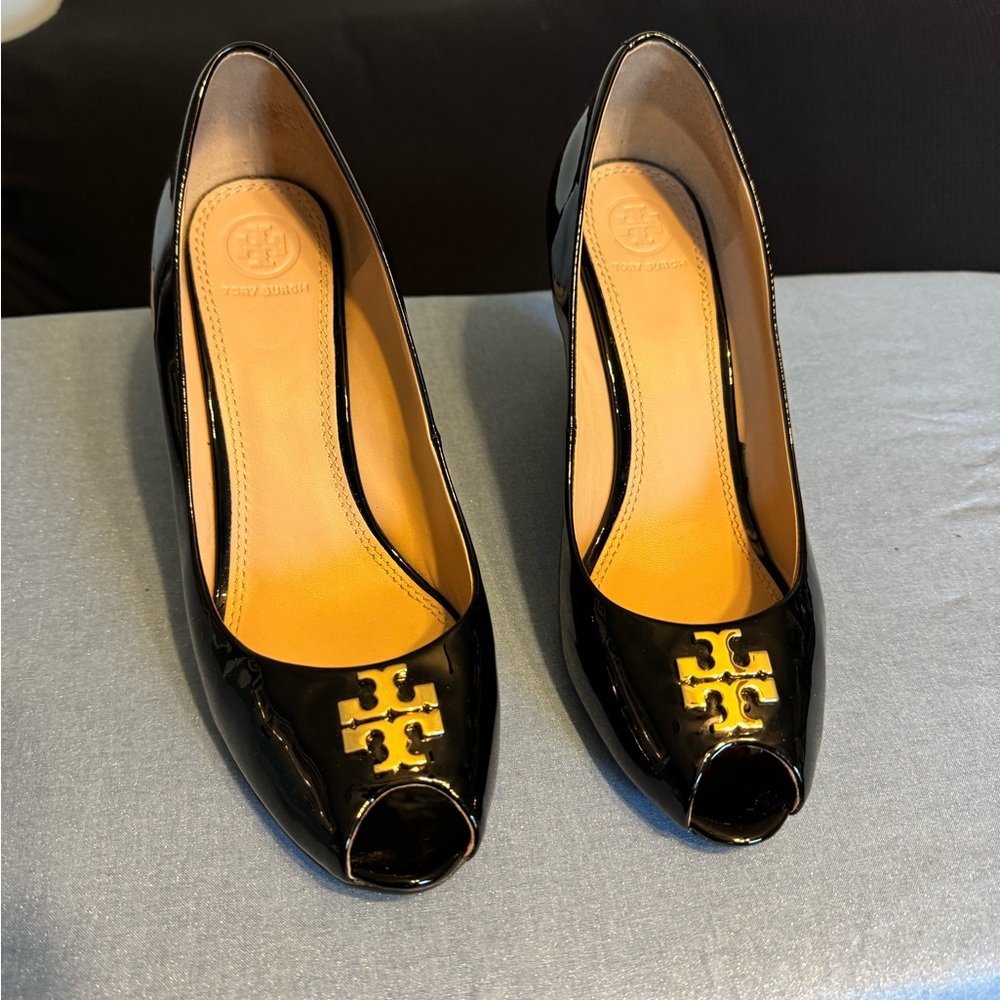 Tory Burch  Black Patene wedge heels with gold emblem in front